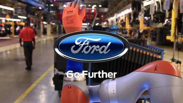 Car Workers and Robots Work Hand in