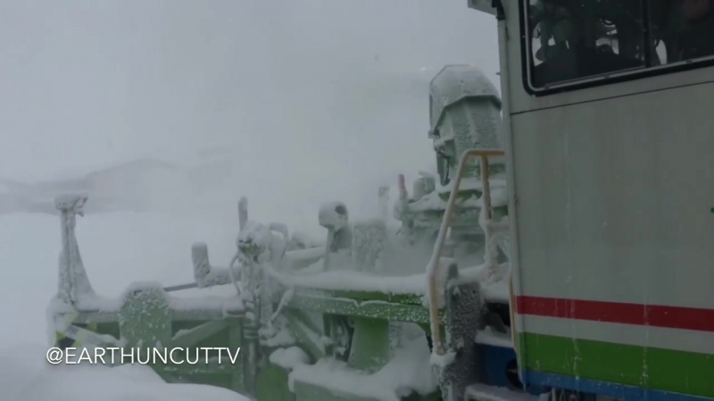 Snow Clearing Train Churns Through Drifts In